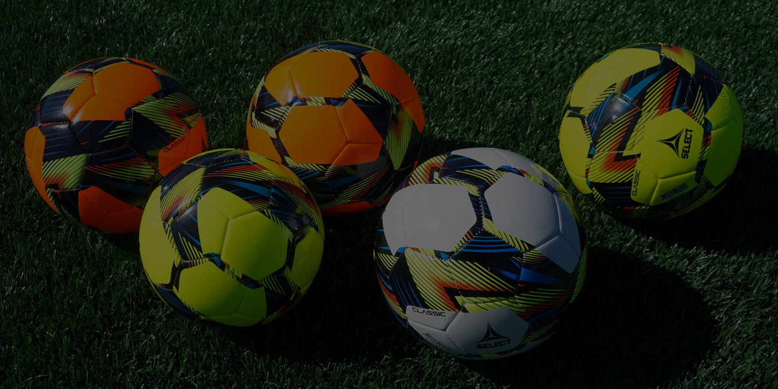 A variety of camp level soccer balls on a soccer field