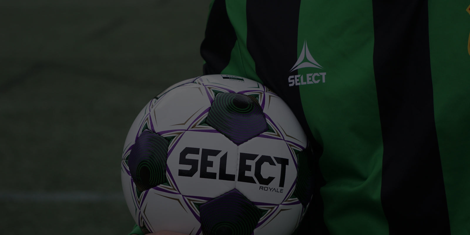 A club level soccer ball being held in a player's hand