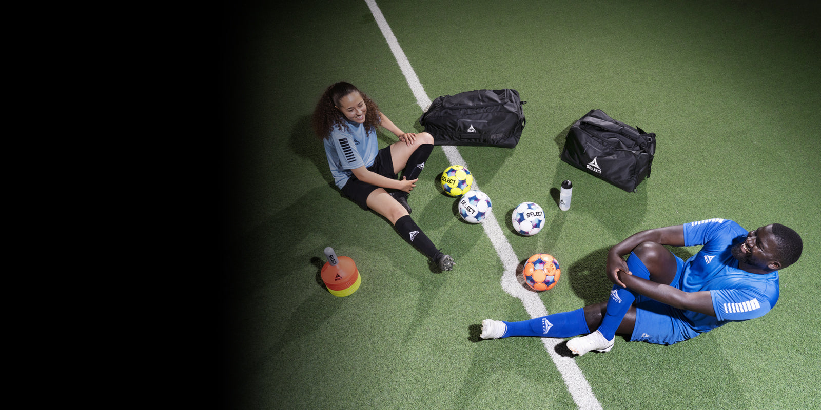 Two soccer players sitting on a soccer field with various equipment. Images fades from black to transparent from left to right