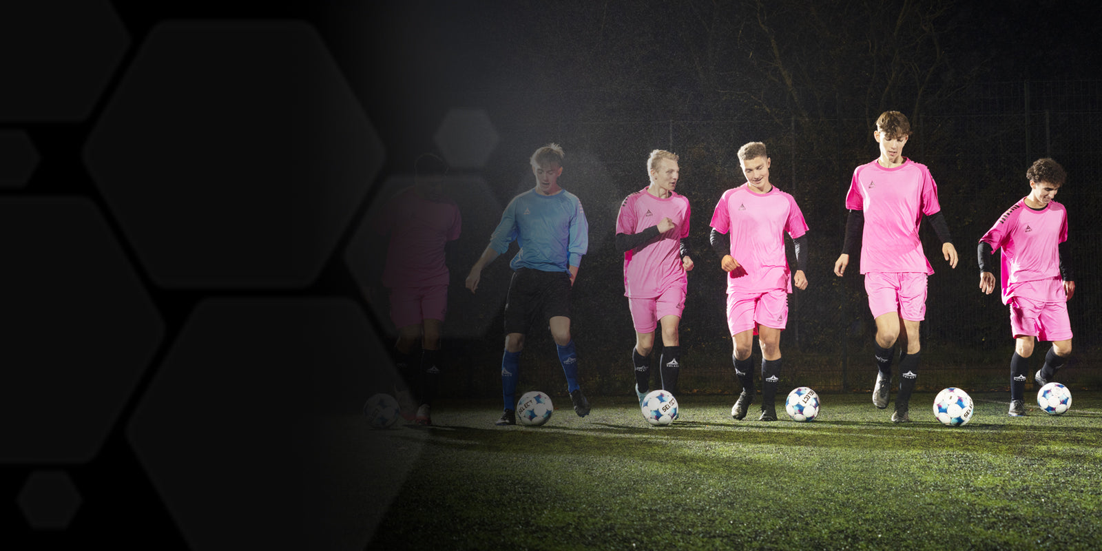 Soccer players lined up dribbling soccer balls