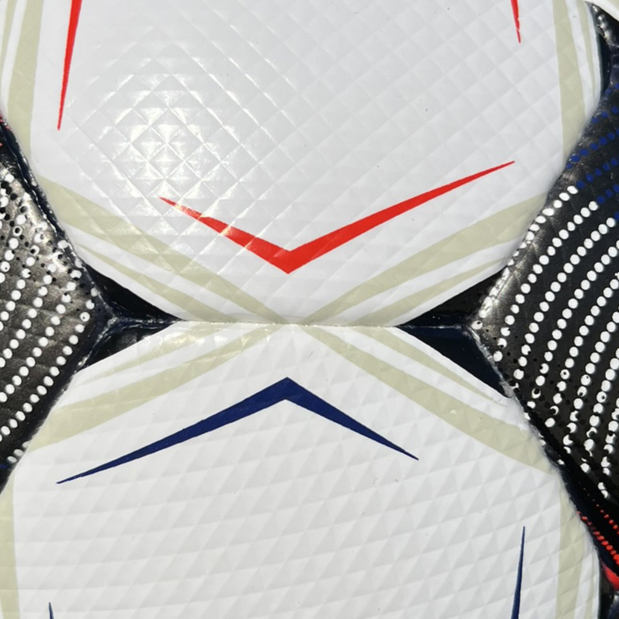 Closeup of a white soccer ball with black, blue, and red accents.