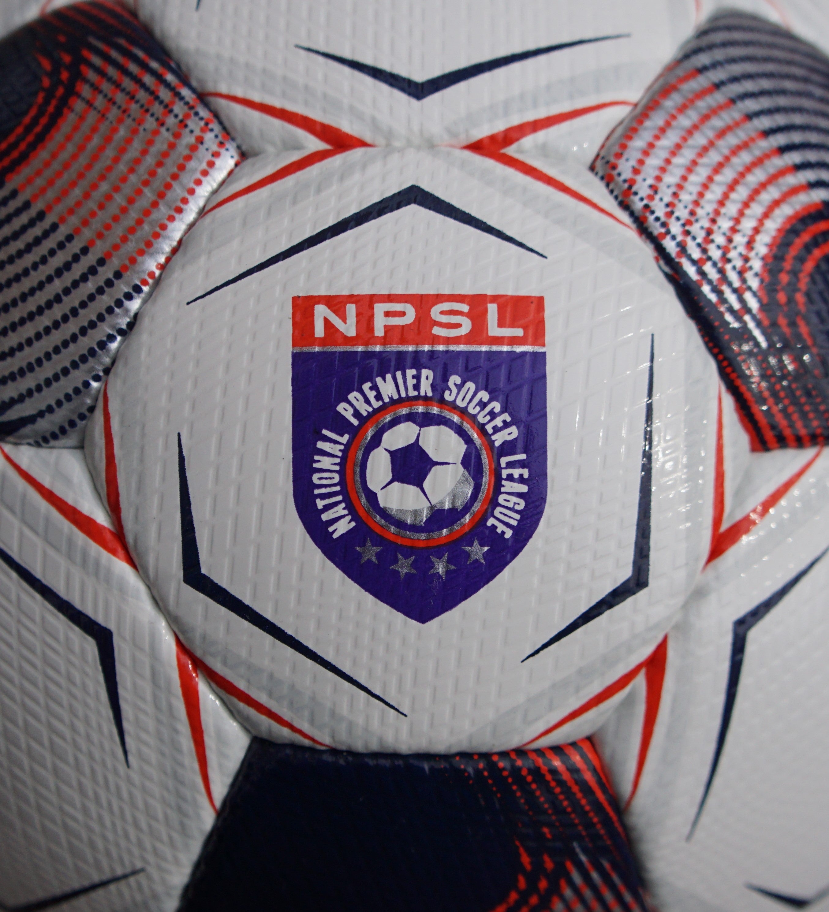 White soccer ball with navy pentagons, silver and red accents and 'Select' branding on a white background. Official ball of the NPSL #color_white/blue