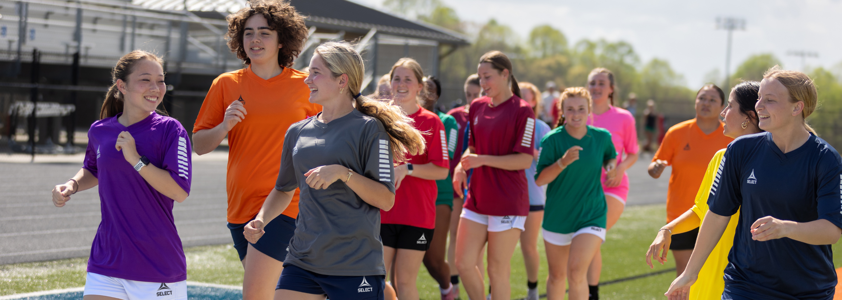 Soccer players wearing the Pisa clothing line in a variety of colors