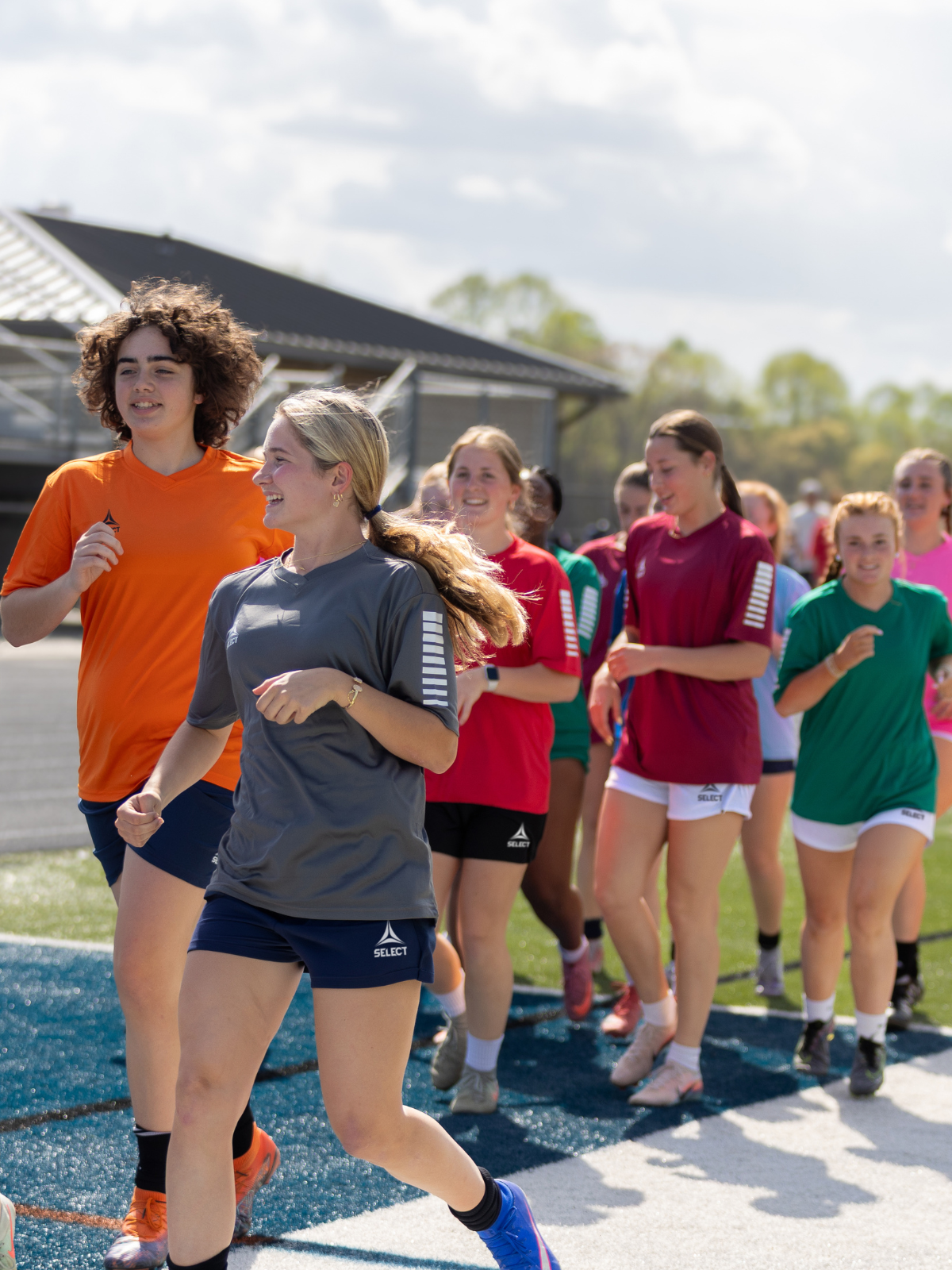 Soccer players wearing the Pisa clothing line in a variety of colors
